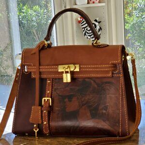 Exquisite, handcrafted leather bag featuring a deliberate craquelure finish